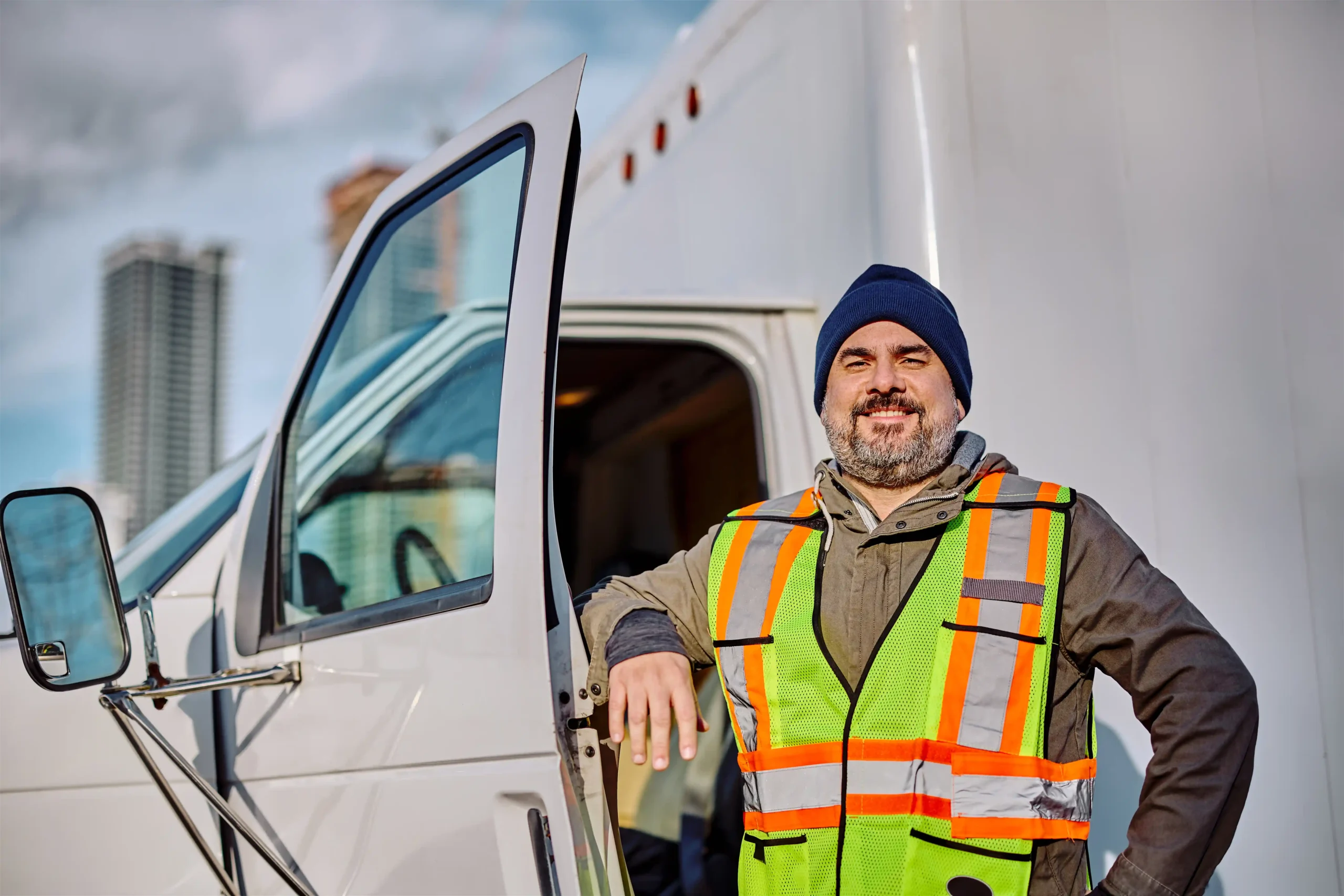 happy-professional-truck-driver-looking-at-camera